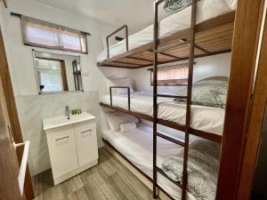 a bunk bed room with two bunk beds and a sink at Young Tourist Park in Young +112 photos