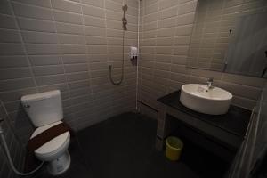 a bathroom with a toilet and a sink at โรงแรมทูมอร์โรว์แลนด์ อมตะนคร in Ban Khlong Phan Thong