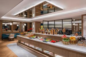 a buffet line in a hotel with fruits and vegetables at Manxin Hotel Xian Bell Tower in Xi'an