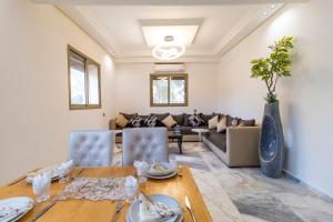 a living room with a table and a couch at Rose Garden Resort & Spa in Marrakesh