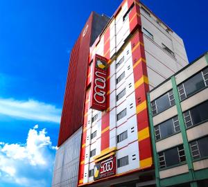 a building with a colgate sign on the side of it at Hotel Sogo Edsa Cubao in Manila