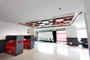 an office lobby with red chairs and a ceiling at Hotel Sogo Edsa Cubao in Manila