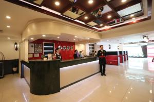 a woman standing in front of a counter in a restaurant at Hotel Sogo Edsa Cubao in Manila