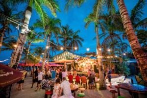 a party on the beach at night with palm trees at Neptunes Hideaway in Vero Beach