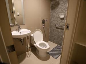 a bathroom with a toilet and a sink at Hotel Sogo Edsa Cubao in Manila +9 photos