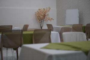 a conference room with tables and chairs and a whiteboard at Hotel Mi Linda Tierra in Quesada +53 photos