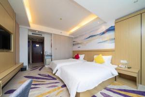 a bedroom with two beds and a flat screen tv at Wanyi Hotel in Dongguan +99 photos
