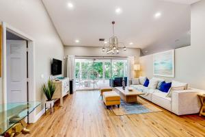 a living room with a couch and a table at Lush Leisure - 816 Twenty Third Ave in Vero Beach