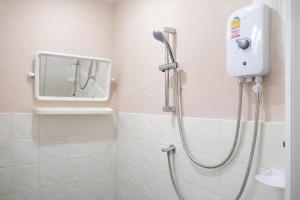 a shower in a bathroom with a mirror and a shower at Pailin Hotel Krabi in Klong Muang Beach