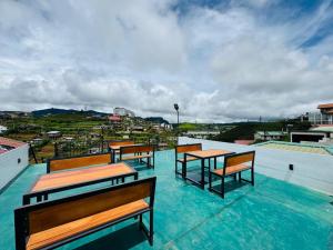 a group of benches sitting on top of a roof at Himawari Hills Hotel and Hostel in Nuwara Eliya