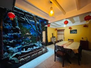 a dining room with a large aquarium and a table at Himawari Hills Hotel and Hostel in Nuwara Eliya