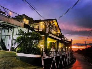 a house with a balcony at night at Himawari Hills Hotel and Hostel in Nuwara Eliya