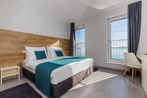 Posteľ alebo postele v izbe v ubytovaní Hotel Štacija