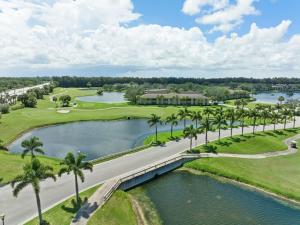 an aerial view of a golf course with a lake and palm trees at 162 Miller Dr in Sebastian