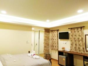 a bedroom with two teddy bears sitting on a bed at The Vintage Residence in Ban Thung Sukla +32 photos