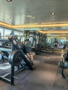 a gym with rows of treadmills and machines at 千禧大厦 in Pattaya South