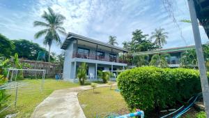 a house with a playground in front of it at Smile Resort Koh Mook in Ko Mook