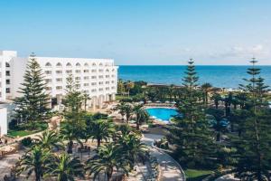 an aerial view of a resort with a pool and the ocean at Iberostar Selection Kantaoui Bay in Port El Kantaoui