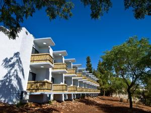 a building with balconies on a hill with trees at EretZefat in Safed