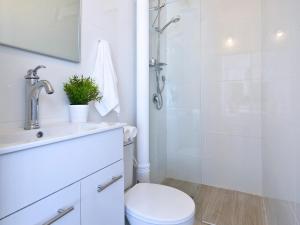 a bathroom with a shower and a toilet and a sink at EretZefat in Safed