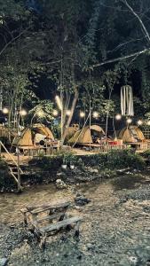 a wooden bench sitting on the beach at night at camp asri in Bukittinggi