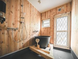 a bathroom with a shower and a bath tub at #65 Stella 八ヶ岳姫木平 in Tateshina