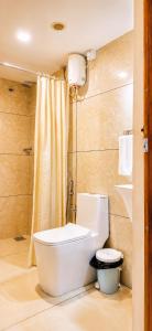a bathroom with a toilet and a shower at Heaven Suite in Kalpetta