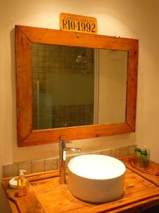 a bathroom with a sink with a mirror and a sink at Nidélice Chambre d'hôtes in Quillan