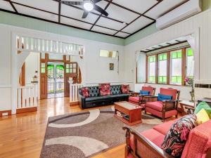 a living room with a couch and chairs at Historic Character-filled Jade Cottage in Coalfalls