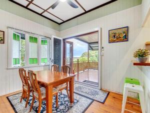 a dining room with a wooden table and chairs at Historic Character-filled Jade Cottage in Coalfalls +9 photos
