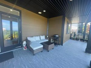 a screened in porch with a couch and a table at Sea view villa independent access in Nanaimo