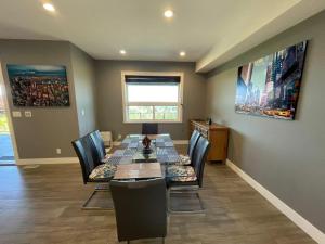 a dining room with a long table and chairs at Sea view villa independent access in Nanaimo