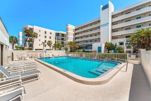 a swimming pool in front of a building at Boardwalk 201 in Cocoa Beach