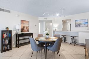 a dining room and kitchen with a table and chairs at Boardwalk 201 in Cocoa Beach