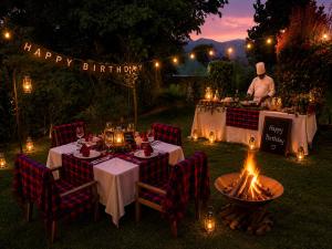 a man standing behind a table with a happy birthday sign at Bwindi Neckview Lodge in Buhoma