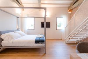 a bedroom with a bed and a dresser at Casa Burano Experience by Venissa in Burano