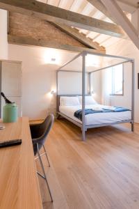 a bedroom with a bed with a metal frame at Casa Burano in Burano