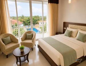 a bedroom with a bed and a large window at Rainbow Seven Hotel in Negombo
