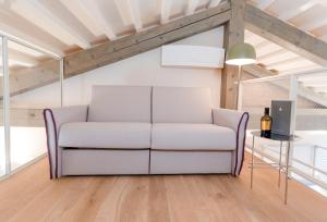 a white couch in a living room with a table at Casa Burano in Burano
