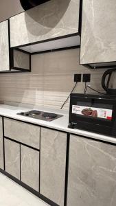 a kitchen with a stove and a counter top at الربوه سويت in Jeddah