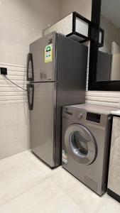a washing machine and a washer in a kitchen at الربوه سويت in Jeddah +6 photos