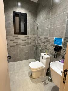 a bathroom with a toilet and a sink at الربوه سويت in Jeddah