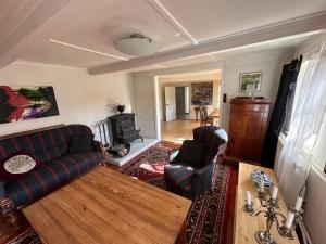 a living room with two couches and a fireplace at Cozy Older Property On Ærø in Søby