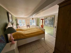 a bedroom with a bed in a room with green walls at Cozy Older Property On Ærø in Søby