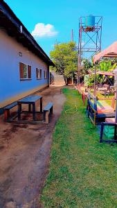 a group of benches sitting next to a building at Quantico Guest house villa in Ndola