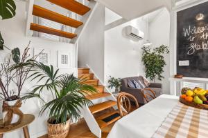 a dining room with a table and chairs and stairs at The Stables - Charming Loft with Derwent River Views in Sandy Bay