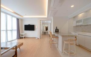 a kitchen and living room with a table and chairs at BS Centum hotel in Busan