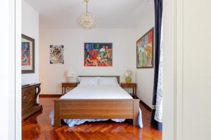 a bedroom with a bed and paintings on the walls at Casa Bianca in Silvi Marina