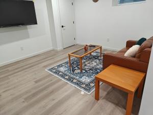 a living room with a couch and a coffee table at New Haven- 2-Bedroom Suite in Winnipeg