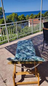 a cushion on a chair on a balcony with the ocean at Apartman Arijeta Korčula in Smokvica +36 photos